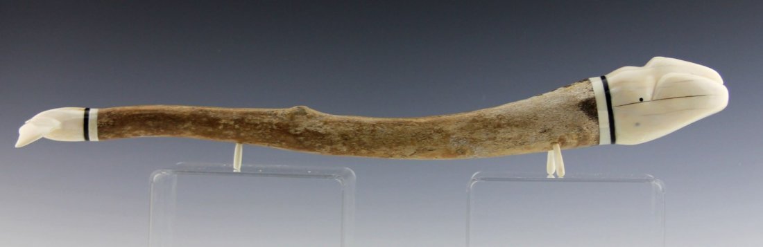 WALRUS OOSIK WHALE CARVING: WALRUS OOSIK WHALE CARVING Walrus oosik, or penis bone, carved in the shape of a whale. Weight: 488 g Size: 18.5"