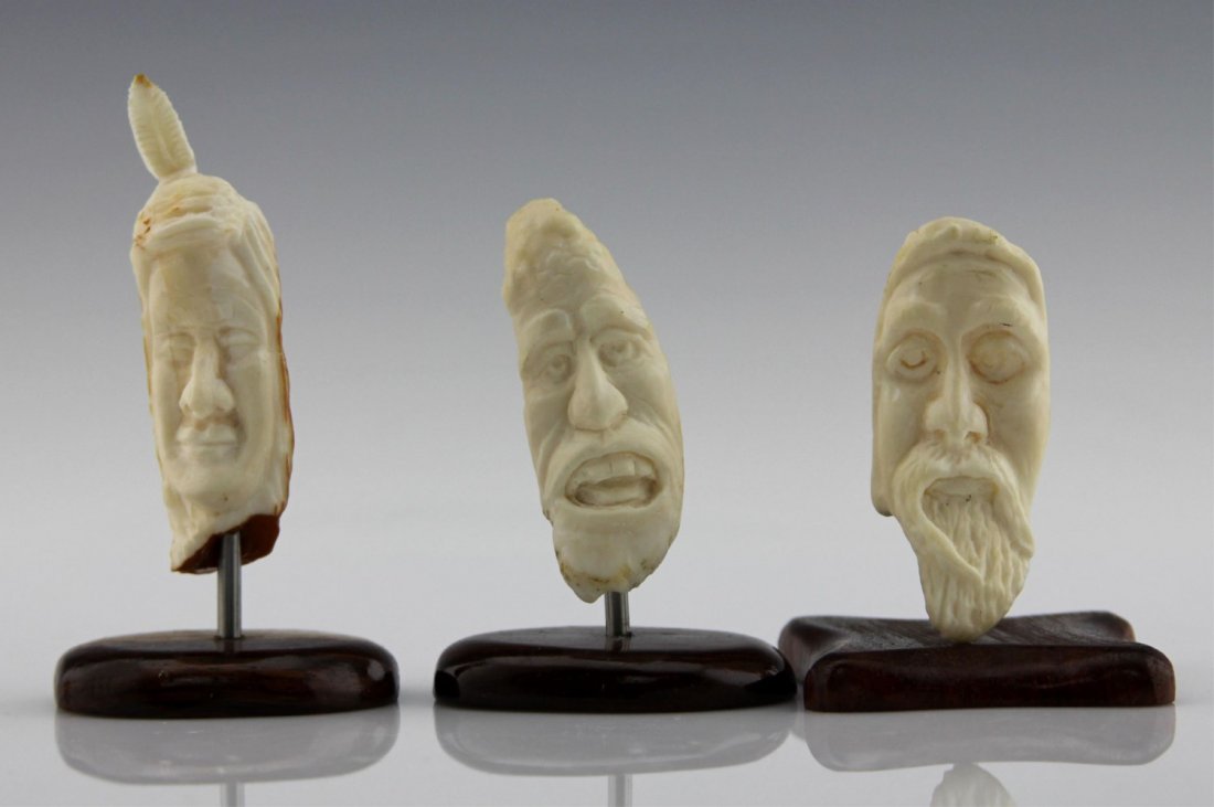(3) INUIT CARVED MARINE IVORY FACES ON STANDS: (3) INUIT CARVED MARINE IVORY FACES ON STANDS Lot of three Inuit carved marine ivory faces, each dowel mounted to wood base. Weight: 90.6 total including bases Size: 2.5" - 3.5"