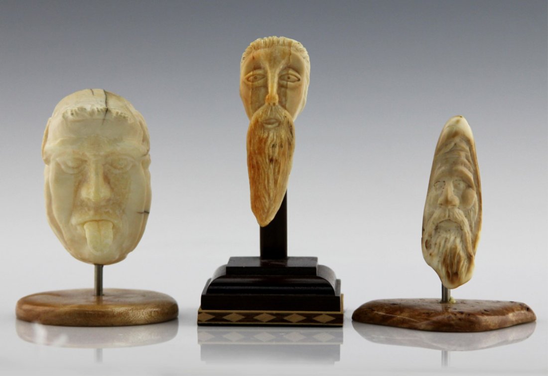 (3) INUIT CARVED MARINE IVORY FACES ON STANDS: (3) INUIT CARVED MARINE IVORY FACES ON STANDS Lot of three Inuit carved marine ivory faces, each includes wood base or stand. Weight: 194.4 total including bases Size: 3.25" - 4"