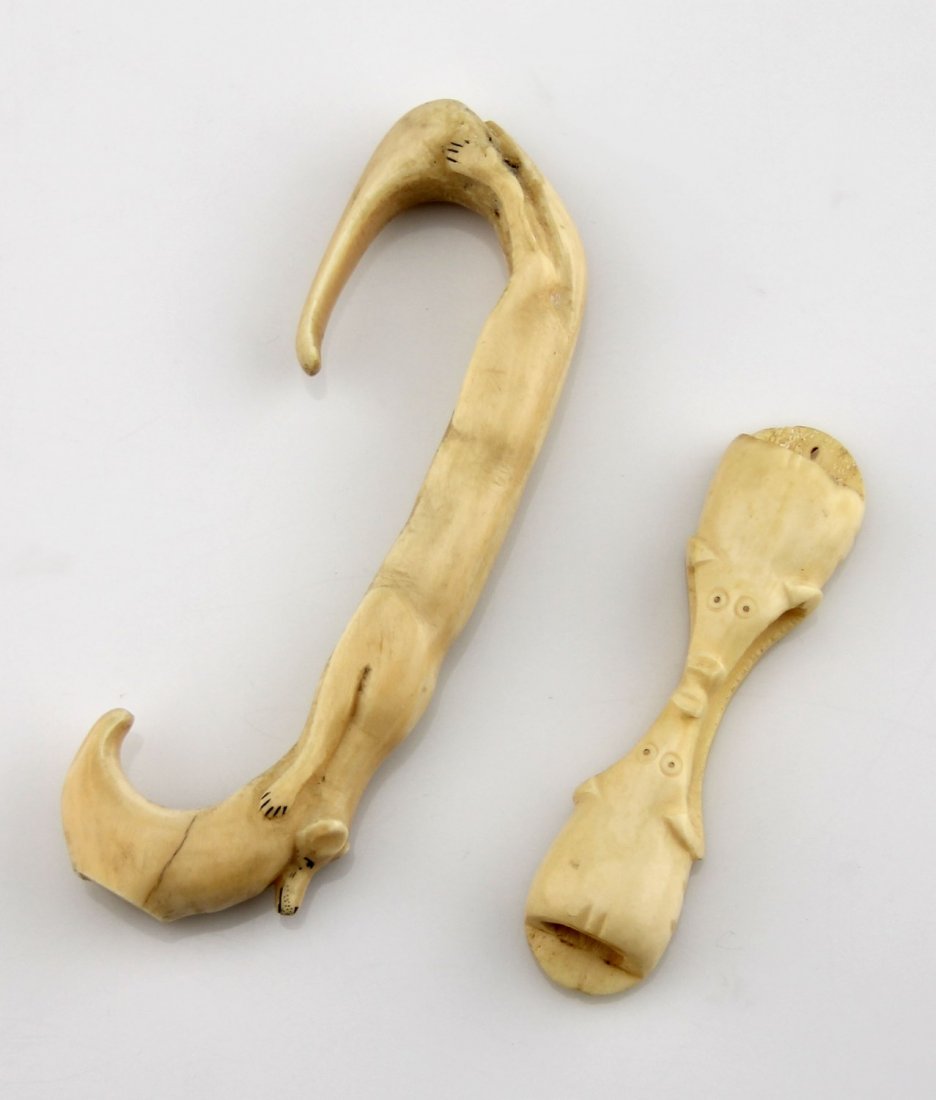 (2) WALRUS IVORY & BONE IMPLEMENTS: (2) WALRUS IVORY & BONE IMPLEMENTS Lot of two; Carved bone elephant motif napkin ring/holder, 4", and a walrus ivory fox motif implement, 6" . Weight: 117.6g total