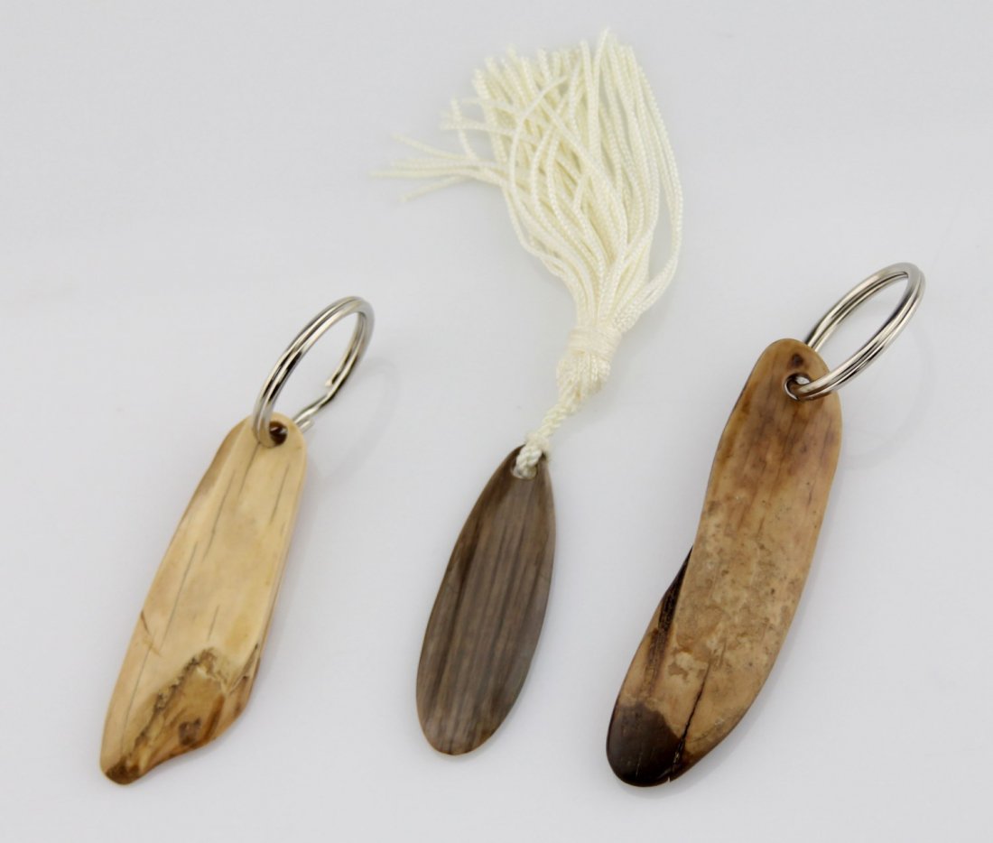 (3) FOSSILIZED MAMMOTH IVORY KEY CHAINS: (3) FOSSILIZED MAMMOTH IVORY KEY CHAINS Lot of three fossilized mammoth ivory key chains, unworked. Weight: 55.5g total Size: 2.25" - 3.25" excluding rings