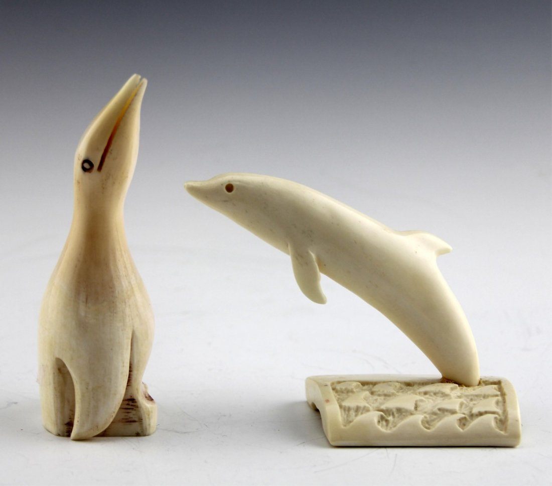 (2) CARVED MARINE IVORY PIECES PENGUIN & DOLPHIN: (2) CARVED MARINE IVORY PIECES PENGUIN & DOLPHIN Lot of two marine ivory pieces: Includes figural penguin, 4.25", and leaping dolphin on wave motif base, 3", inscribed with signature on underside. Wei