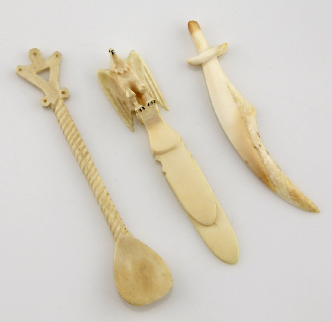 (3) WALRUS IVORY ITEMS SPOON CLIP & SWORD: (3) WALRUS IVORY ITEMS SPOON CLIP & SWORD Lot of three carved walrus ivory items; Includes small spoon with twisted handle, 4.25", card clip or bookmark topped with eagle motif finial, 3.75", and a sm