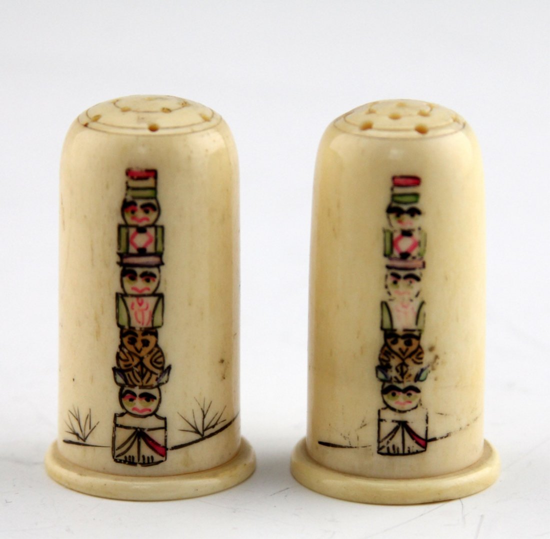 (2) MARINE IVORY SALT & PEPPER SHAKERS TOTEM MOTIF: (2) MARINE IVORY SALT & PEPPER SHAKERS TOTEM MOTIF Lot of two marine ivory salt and pepper shakers; Decorated with painted monochrome totem pole motif and inscribed "Victoria. B. C." on reverse. Weigh