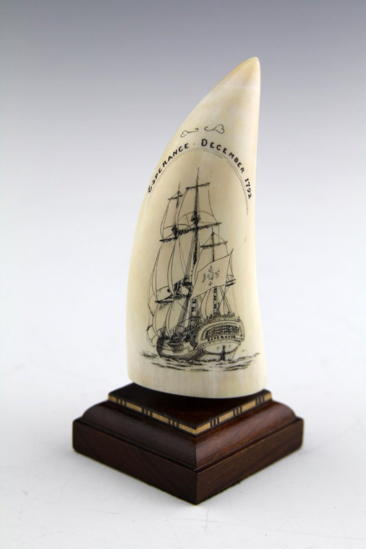 SCRIMSHAW IVORY WHALE TOOTH NAVAL SHIPS: SCRIMSHAW IVORY WHALE TOOTH NAVAL SHIPS Scrimshaw ivory whale tooth depicting two naval ships; "Esperance" and "The Recherche". Also marked "Jesper 1992 Albany" on reverse. Dowel mounted to wood base 