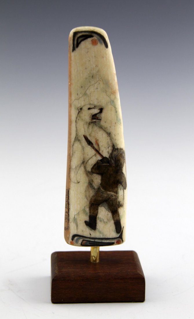 FOSSILIZED WALRUS IVORY SCRIMSHAW MAN W BEAR: FOSSILIZED WALRUS IVORY SCRIMSHAW MAN W BEAR Fossilized walrus ivory segment with polychrome North American scrimshaw depicting a figure fighting a polar bear. Dowel mounted wood base. Weight: 180.6g 