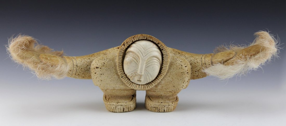 KENT HEINDEL FOSSILIZED WHALE BONE & IVORY DANCER: KENT HEINDEL FOSSILIZED WHALE BONE & IVORY DANCER Native dancer statue by Alaskan artist Kent Heindel, former sculptor of Ekemo Studios in Eagle River, AK; carved fossilized whale bone with ivory face