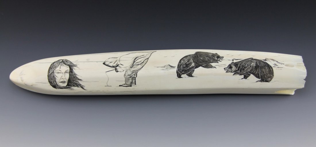 ALASKAN SCRIMSHAW WALRUS TUSK: ALASKAN SCRIMSHAW WALRUS TUSK Walrus tusk with with monochrome scrimshaw depicting Alaskan iconography; native female portrait, a figure ice fishing, and two sparring grizzlies. Size: 19"
