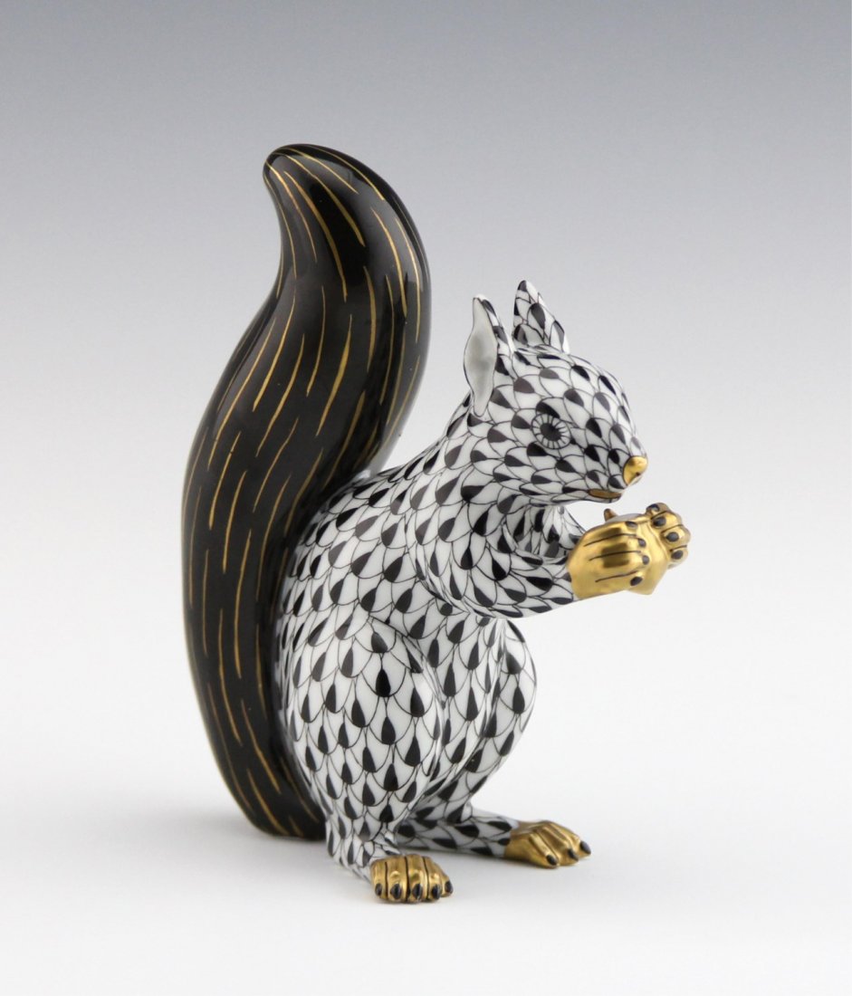 HEREND PORCELAIN SQUIRREL BLACK FISHNET: HEREND PORCELAIN SQUIRREL BLACK FISHNET Herend hand-painted porcelain seated squirrel in black fishnet. Marked on underside. Size: 4.5"