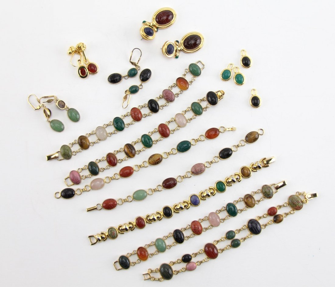 (15) GOLD TONE SCARAB MOTIF COSTUME JEWELRY: (15) GOLD TONE SCARAB MOTIF COSTUME JEWELRY Lot of gold tone costume jewelry with colored glass scarabs. Fifteen pieces total including (7) bracelets, (4) pendants, and (4) pairs of earrings. Weight: 