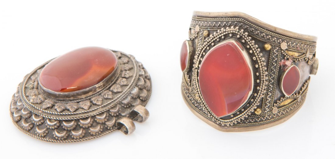 (2) SILVER & CARNELIAN CUFF BRACELET & PENDANT: (2) SILVER & CARNELIAN CUFF BRACELET & PENDANT Lot of two silver jewelry pieces. Includes cuff bracelet with vermeil details and a large pendant with cabochon carnelian. Unmarked, tested. Weight: 163.