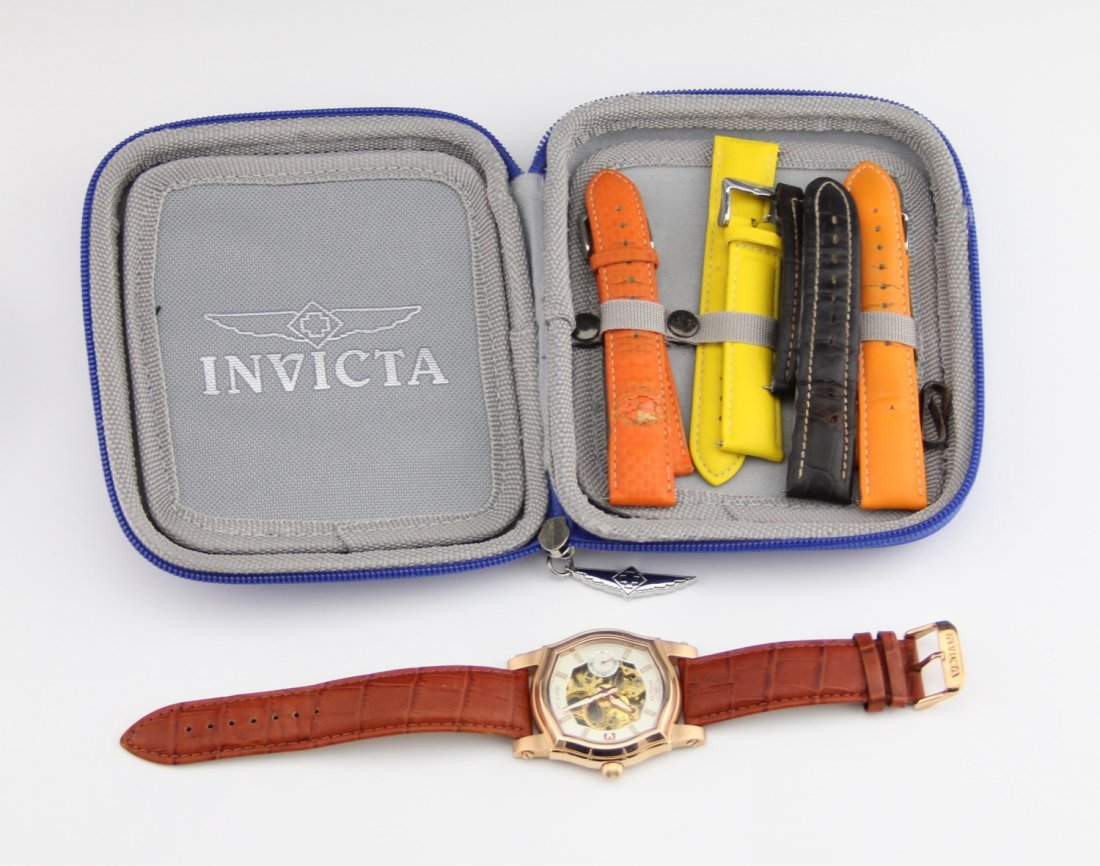 MEN'S INVICTA SKELETON MANUAL WATCH W BANDS: MEN'S INVICTA SKELETON MANUAL WATCH W BANDS Men's Invicta no. 2049 skeleton watch with rose gold toned case, 18 jewels with leather band. Includes four extra bands in Invicta case. Does not include bo