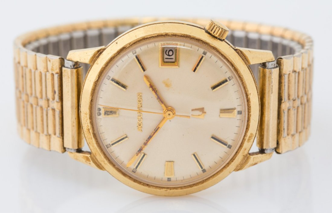 MENS ACCUTRON WRIST WATCH WITH 14K GOLD CASE: MENS ACCUTRON WRIST WATCH WITH 14K GOLD CASE Mens Accutron wrist watch with 14K yellow gold case and Speidel band. Case #F29205. The back of the case is Bulova. Weight: 59.9g Size: 13.5mm