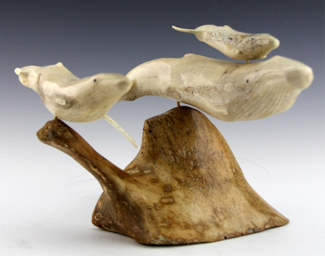 WALRUS IVORY CARVING OF WHALE GROUPING: WALRUS IVORY CARVING OF WHALE GROUPING Walrus ivory carving of three whales; adult, baby, and juvenile. Pin mounted to darker toned fossilized bone base. Size: 12 x 5.75"