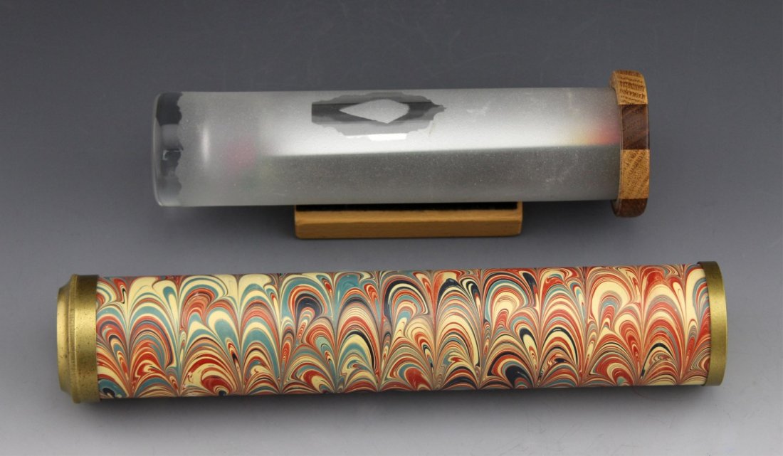 (2) DECORATIVE KALEIDOSCOPES: (2) DECORATIVE KALEIDOSCOPES Two decorative kaleidoscopes, one with a swirl pattern by Van Cort Instruments (10") and the other glass with a wooden view cover and a stand (7.5").