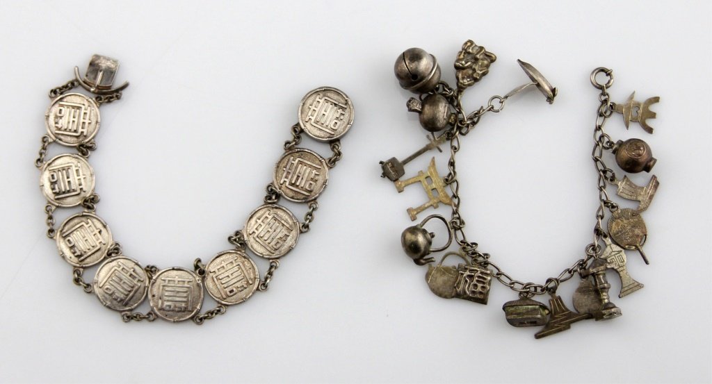 (2) STERLING ASIAN CALLIGRAPHIC LINK BRACELETS: (2) STERLING ASIAN CALLIGRAPHIC LINK BRACELETS Two sterling silver Asian calligraphic link bracelets. One with round links, and the other more like a charm bracelet with varying symbols. Weight: 54.7g