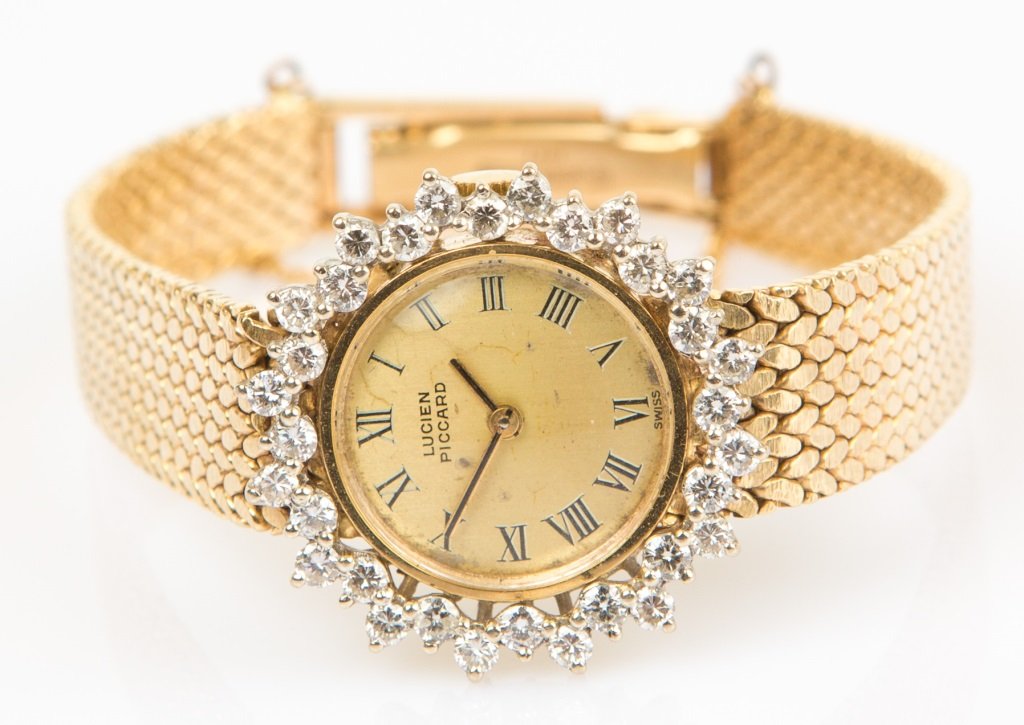 LUCIEN PICCARD LADIES 14K YELLOW GOLD WATCH: LUCIEN PICCARD LADIES 14K YELLOW GOLD WATCH Lucien Piccard Ladies 14K yellow gold wrist watch, Case No. C2411; gold tone dial with roman numerals. Beautifully accented with 32 round cut diamonds appro