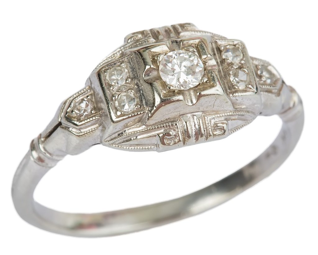 LADIES 18K WHITE GOLD ART DECO DIAMOND RING: LADIES 18K WHITE GOLD ART DECO DIAMOND RING Three antique single cut diamonds totaling .12 carat enhance a .10ct center cut diamond. set in 18K white gold.. intricate design work. Weight: 2.3g Size: 5
