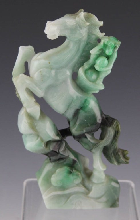 CARVED MOSS AND SNOW HORSE & MONKEY FIGURE: CARVED MOSS AND SNOW HORSE & MONKEY FIGURE Carved moss and snow jade figure of a horse with a monkey riding its back. Weight: 588.9g Size: 6.5"