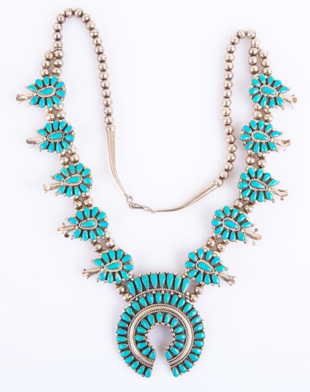 STERLING & TURQUOISE SQUASH BLOSSOM NECKLACE: STERLING & TURQUOISE SQUASH BLOSSOM NECKLACE Sterling and turquoise squash blossom necklace. Signed "JW" on the back of the center piece. Weight: 122.5g Size: 30"