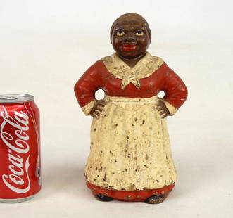 Mammy Doorstop: C. 1920 Mammy in red dress cast iron doorstop. Hubley Foundry, Lancaster, Penna., original paint. Ref: "Ref: "The Doorstop Book", p. 218 (Smith). 9" Ht..
