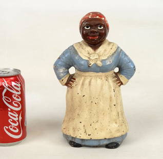 Mammy Doorstop: C. 1920 Mammy in blue dress cast iron doorstop. Hubley Foundry, Lancaster, Penna., original paint. Ref: "The Doorstop Book", p. 218 (Smith). 9" Ht..