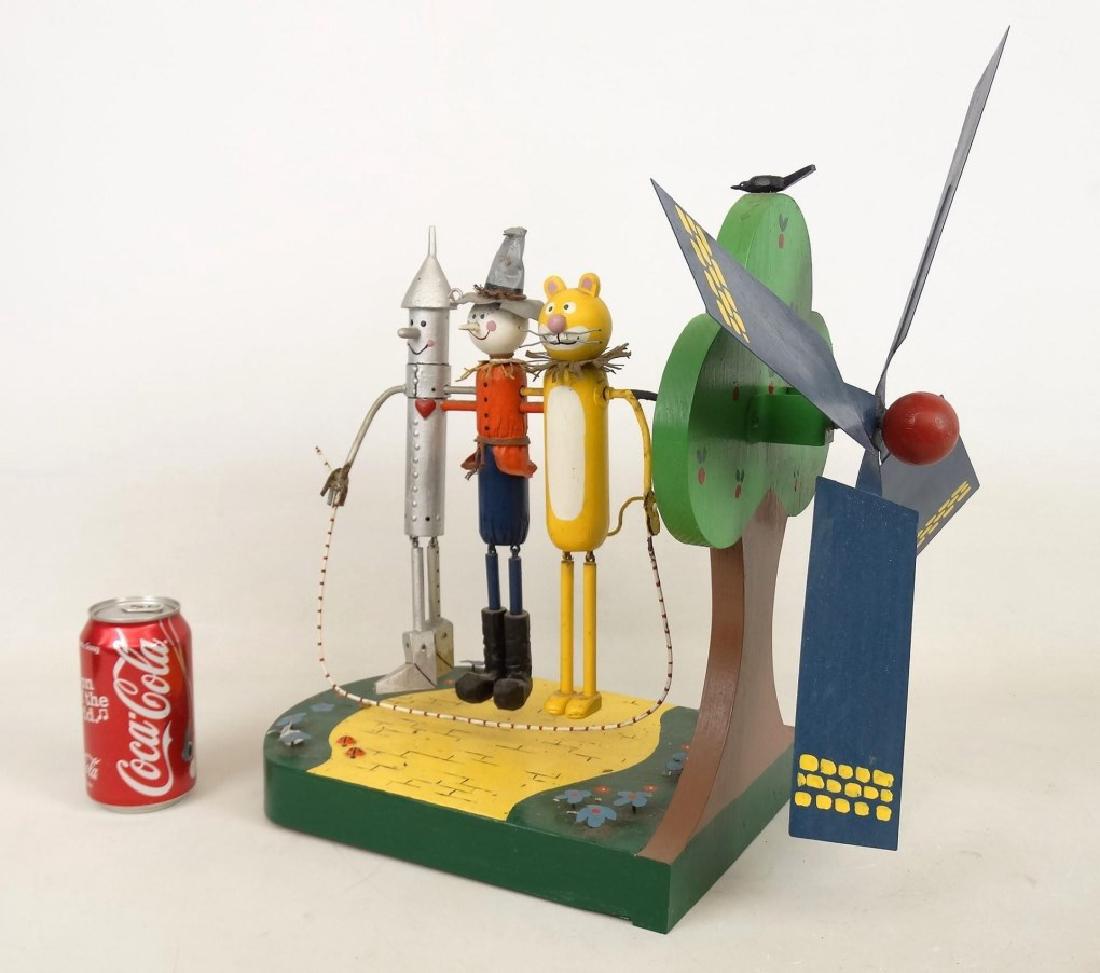 Wizard Of Oz Whirligig: Folk art wooden polychrome painted whirligig. Signed underside. 14" x 9" x 19" Ht.. Signed underside "CB Richard" (?).