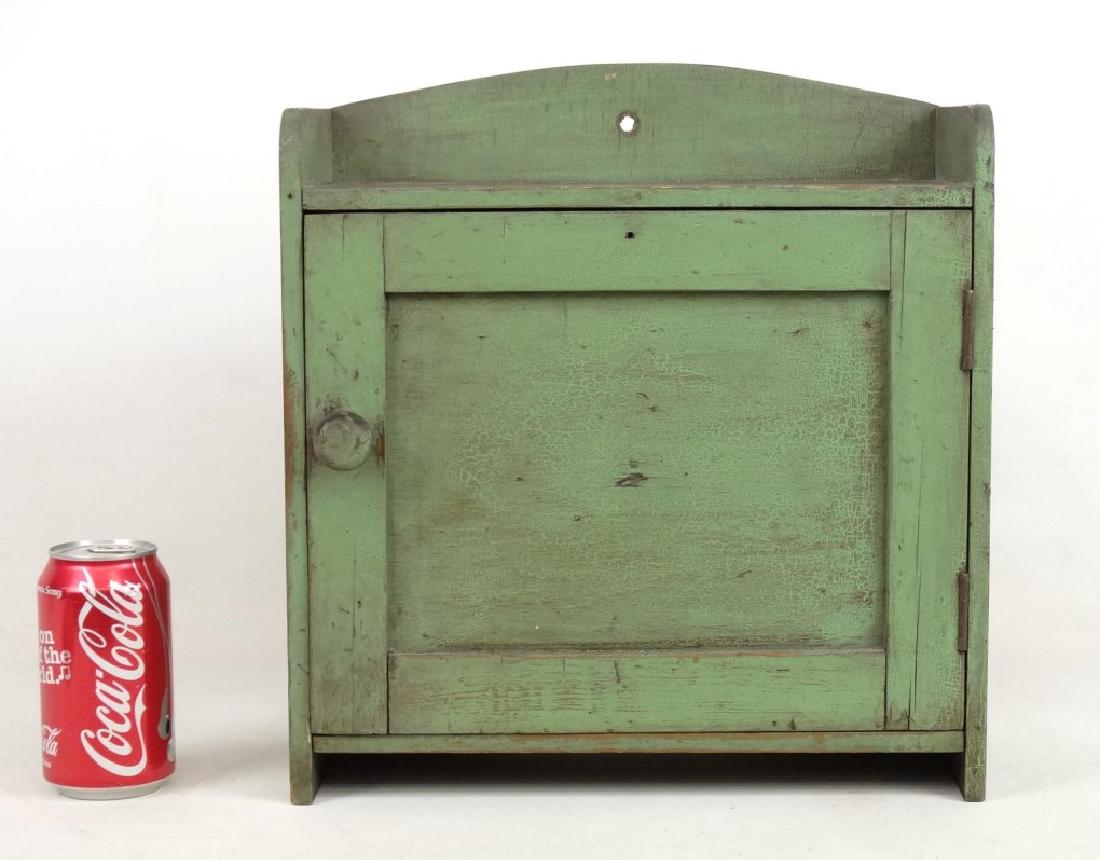 Hanging Cupboard: Early hanging cupboard in old green paint. 13 1/2" x 6" x 14 1/4" Ht..