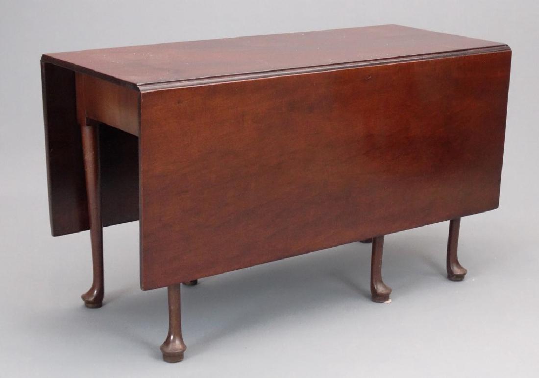 Queen Anne Style Table: Queen Anne mahogany dining table. Top 19" x 49" with 19" leaves, 28 1/2" Ht..