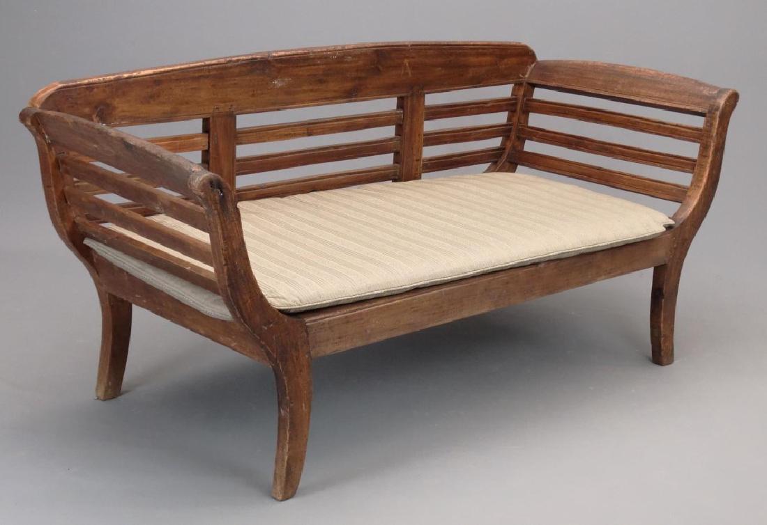 Teak Settee: Decorative teak settee with cushion. 64" x 28" x 31".