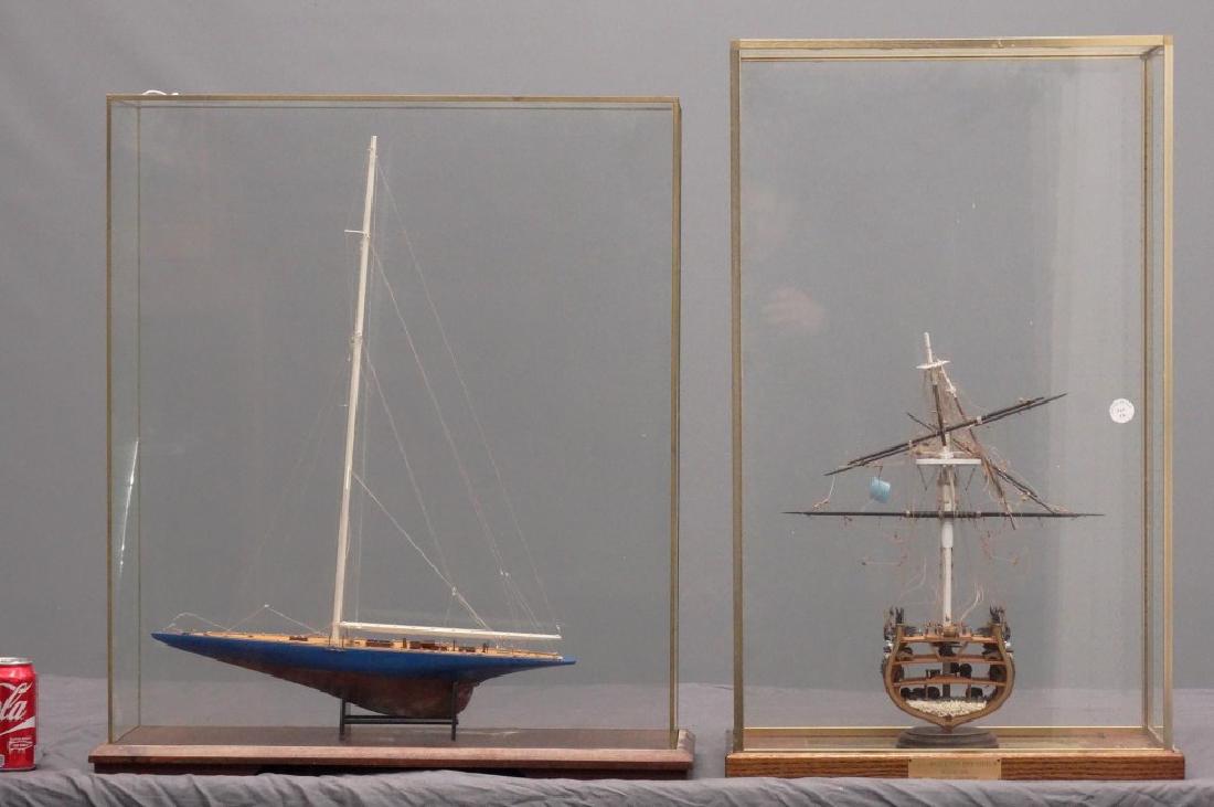 Ship Models: Two Ship models in cases. Case cracked. 24" x 7 1/2" x 28" Ht., 19" x 9" x 31".