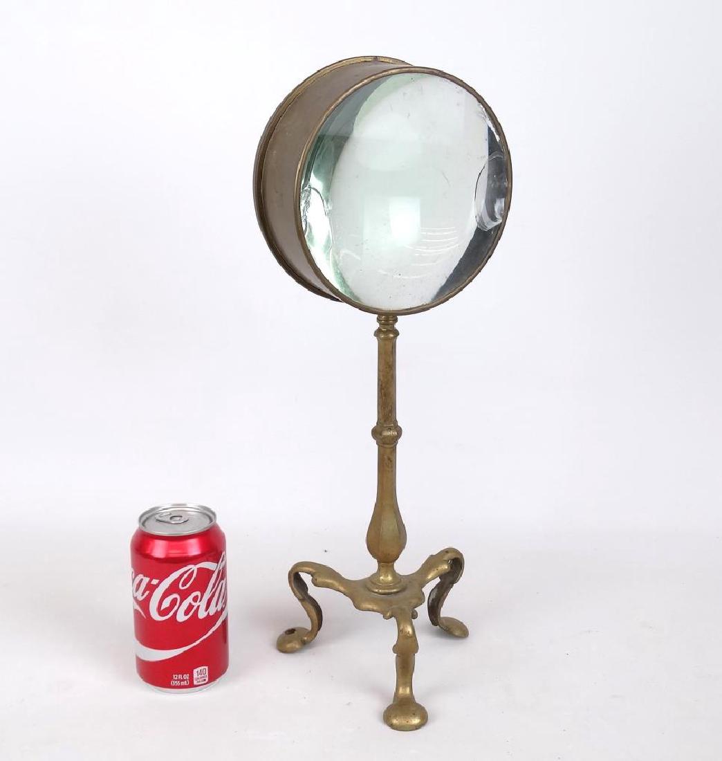 Early Brass Magnifying Glass: Early brass table magnifying glass. 17" Ht.. Lens as is.