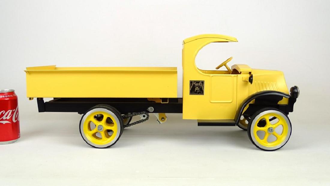 Les Paul Mack Dump Truck Toy: A “Les Paul” Mack tan and black dump truck. 24" L..