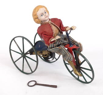 Stevens Brown Girl On Velocipede Toy: 9th c. Stevens Brown girl on velocipede toy. Original clothing intact. Clockwork C. 1875. Works. Retains original key. 11 1/2" L., 9 1/2" Ht.. Mechanical toy, girl seated on tinplate velocipede with