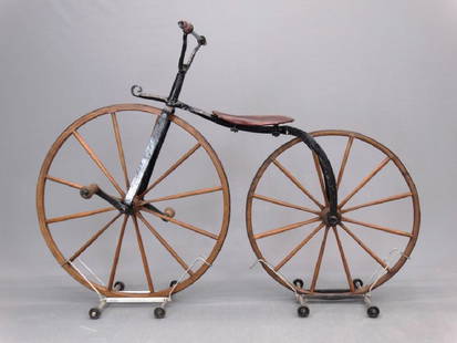 C. 1860's Boneshaker Bicycle: C. 1860's boneshaker bicycle. 39" front wheel, 24" rear wheel. Good condition. Sold at Copake Auction April 21, 2001 (lot 186).