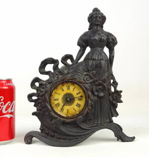 Cast Iron Figural Clock: C. 1890's "Columbian" cast iron figural mantle clock. 10 1/2" Ht..