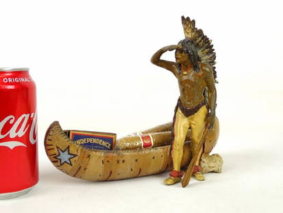 Cast Metal Native American Cigar Holder: Early painted cast metal figural Native American with canoe cigar holder. 8" W., 7" Ht..