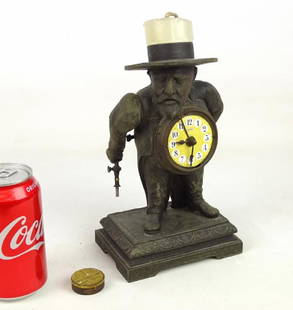 Figural Man Cigar Lighter: Rare figural man cigar lighter / candle night light. Spelter metal with porcelain clock. 9 1/2" Ht.. Comes with 1" tin "MAGIC POCKET LAMP".