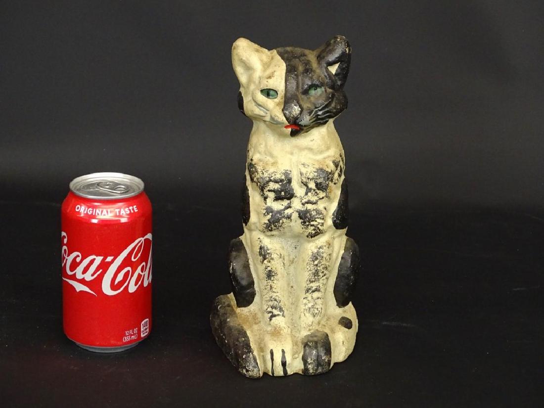 Cat Doorstop: Cast iron cat doorstop. Impressed backside "CN". 9 1/4" Ht..
