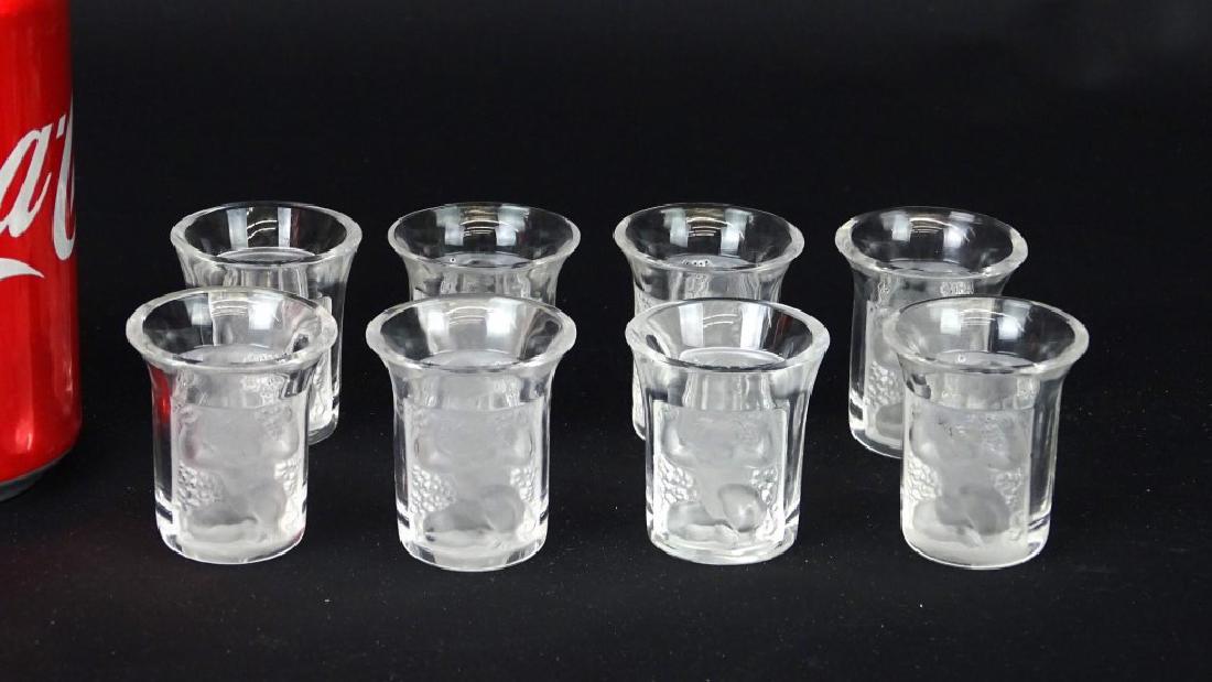 Lalique Shot Glasses: Set of (8) signed Lalique shot glasses. 2" Ht.. Cherub decorated.