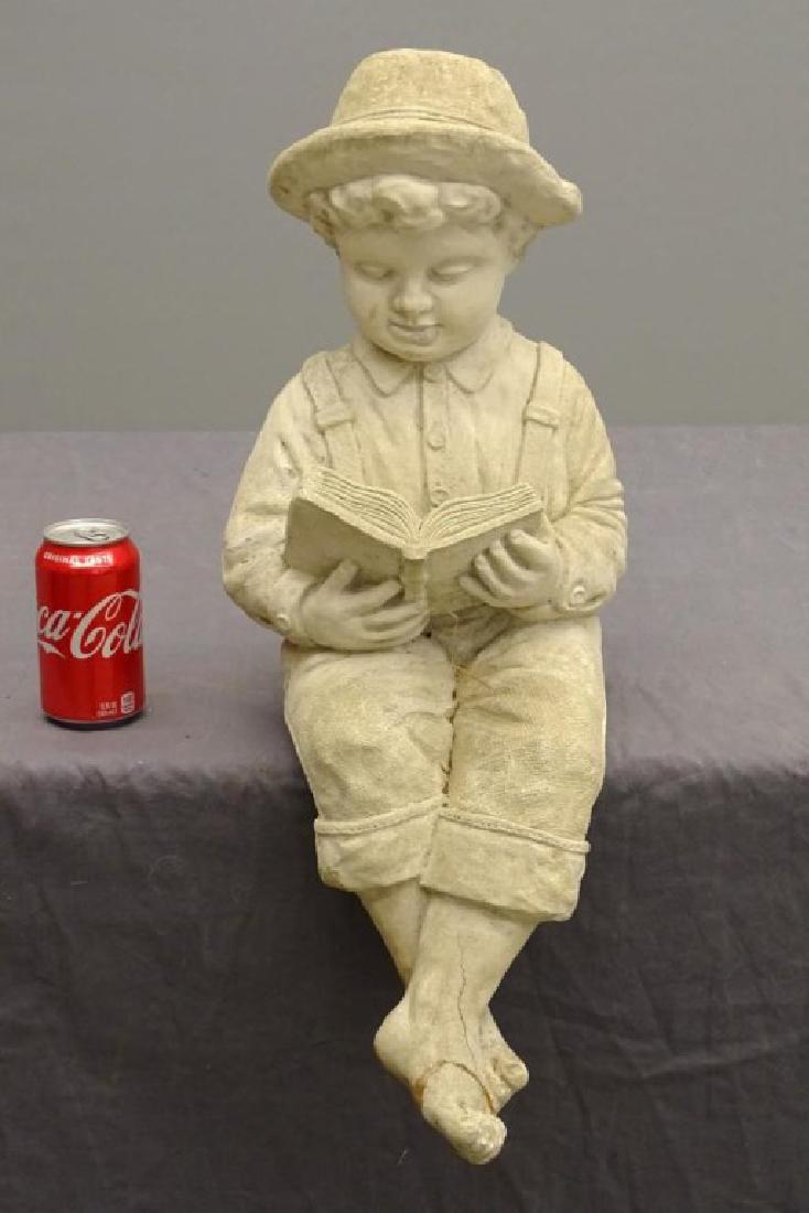 Cement Statue: Cement statue of seated boy. 24" Ht.. Foot repaired.
