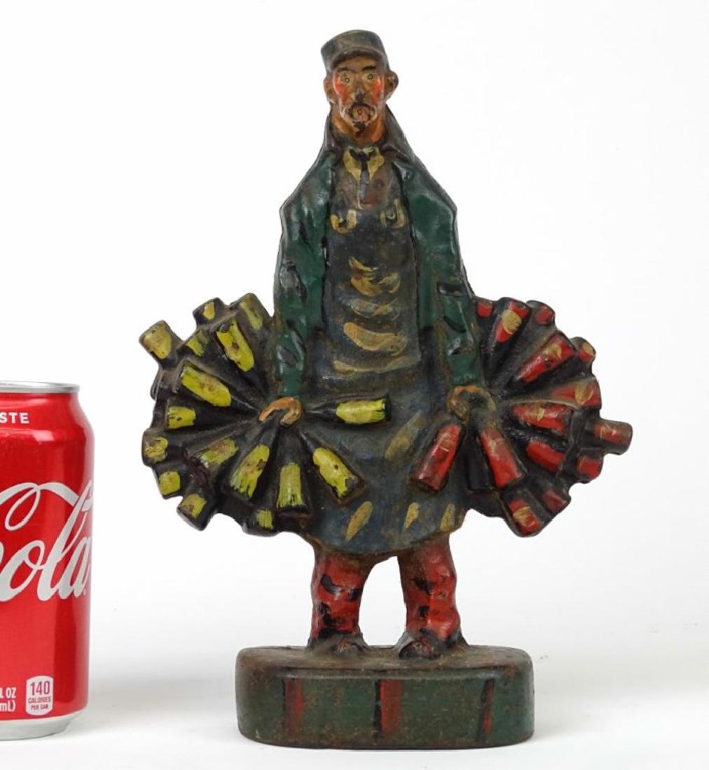 Wine Merchant Doorstop: C. 1920 cast iron Wine Merchant doorstop. Original paint. 10" Ht.. Reference: "The Doorstop Book" (Smith, page 206).