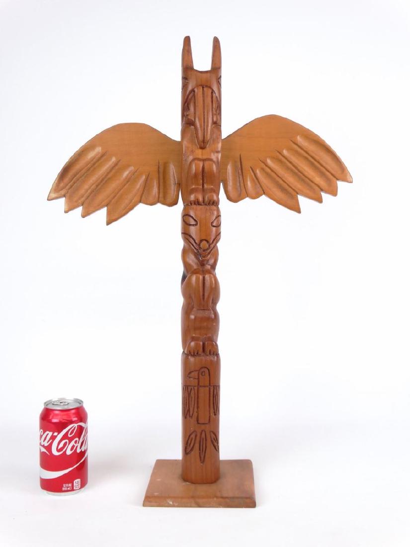 Northwest Carved Totem Pole: Northwest carved wooden totem pole. 25" Ht., 16" W..