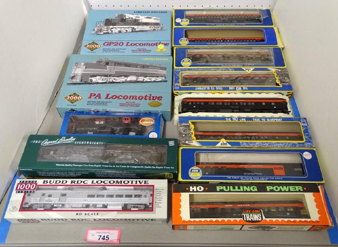 HO Scale Model Train Lot: HO Scale model train lot "New Haven" including: (2) #0272 locomotives, #1606 locomotives, silver "US Mail Car, (8) passenger cars, Green #8262 car. Most in boxes.