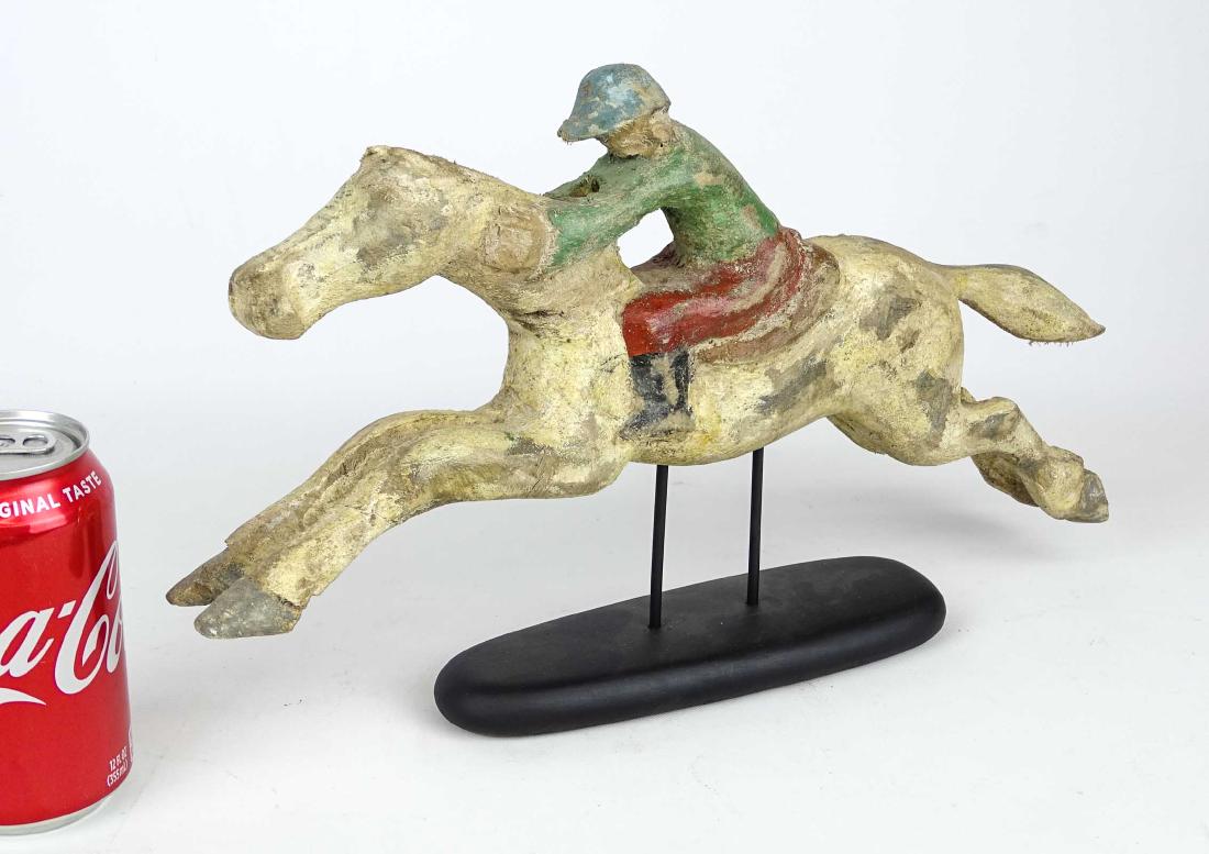 Folk Art Horse And Jockey Arcade Figure: Folk art painted wooden horse and jockey arcade figure. 15" L., 9 1/2" Ht. on stand.