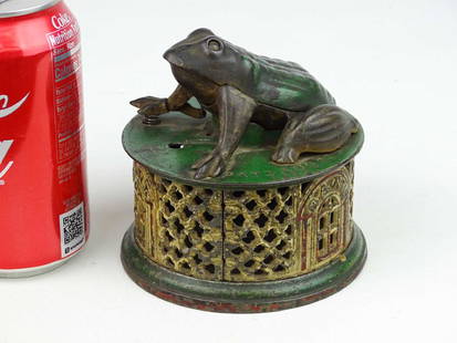 Frog On Lattice Mechanical Bank: Early cast iron Frog On Lattice mechanical bank. Pat. 8/20/72, J. & E. Stevens Co.. 4 1/2" D., 4 1/2" Ht.. Original paint.