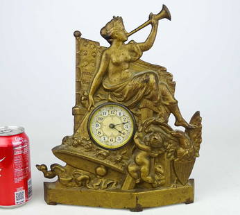 Cast Iron Figural Clock: C. 1900 cast iron figural clock with Lady Columbia, Bell, Cherub and Flag. 10 1/2" x 12 3/4".