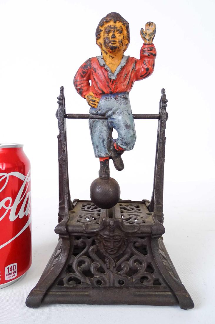 Boy On Trapeze Mechanical Bank: C. 1888 Boy On Trapeze cast iron mechanical bank. J. Barton Smith & Co., Philadelphia. 5" x 5" x 9 1/2".