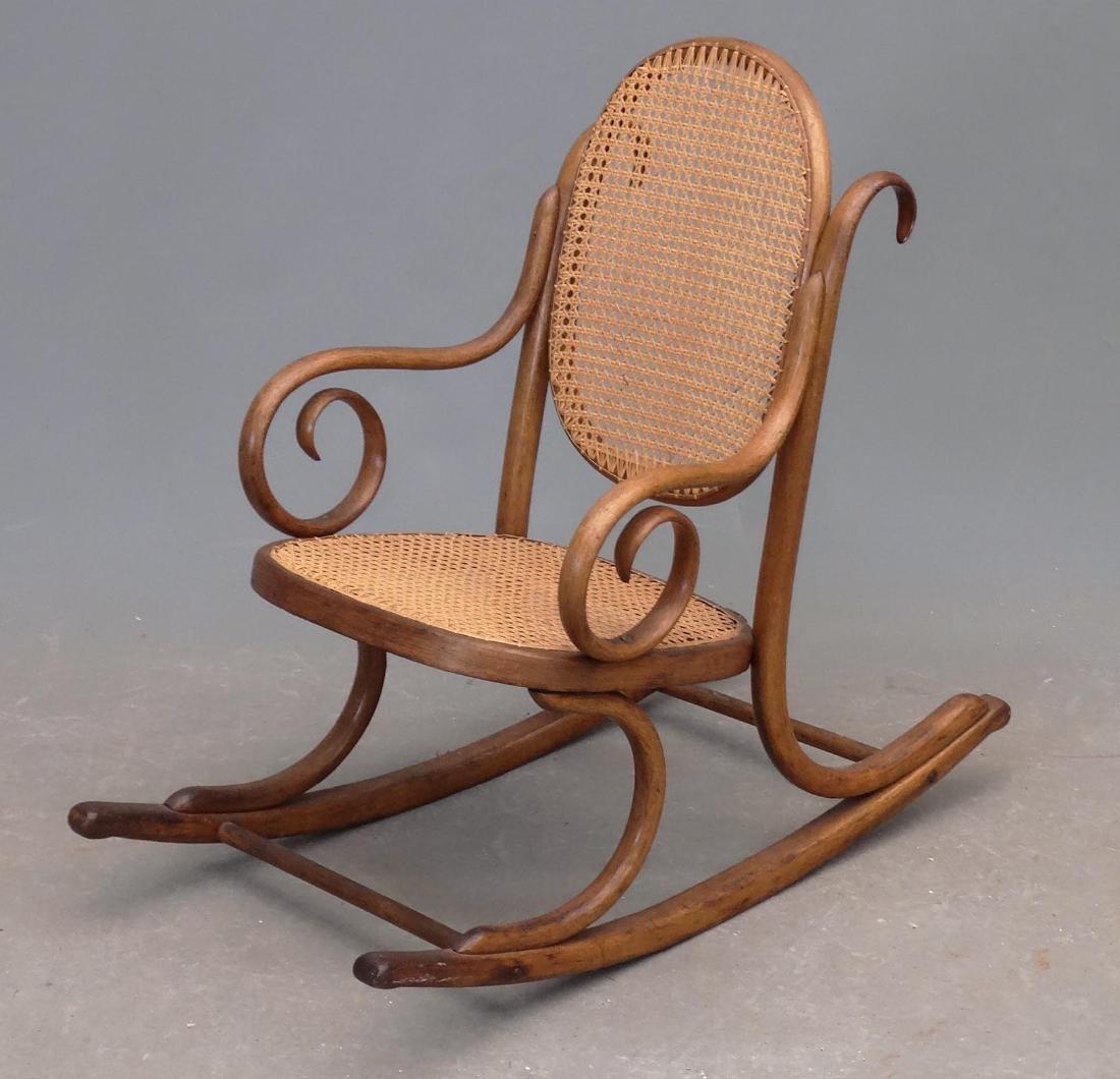 Child's Bentwood Rocking Chair: C. 1900's child's bentwood rocking chair with cane seat. 26" overall Ht..