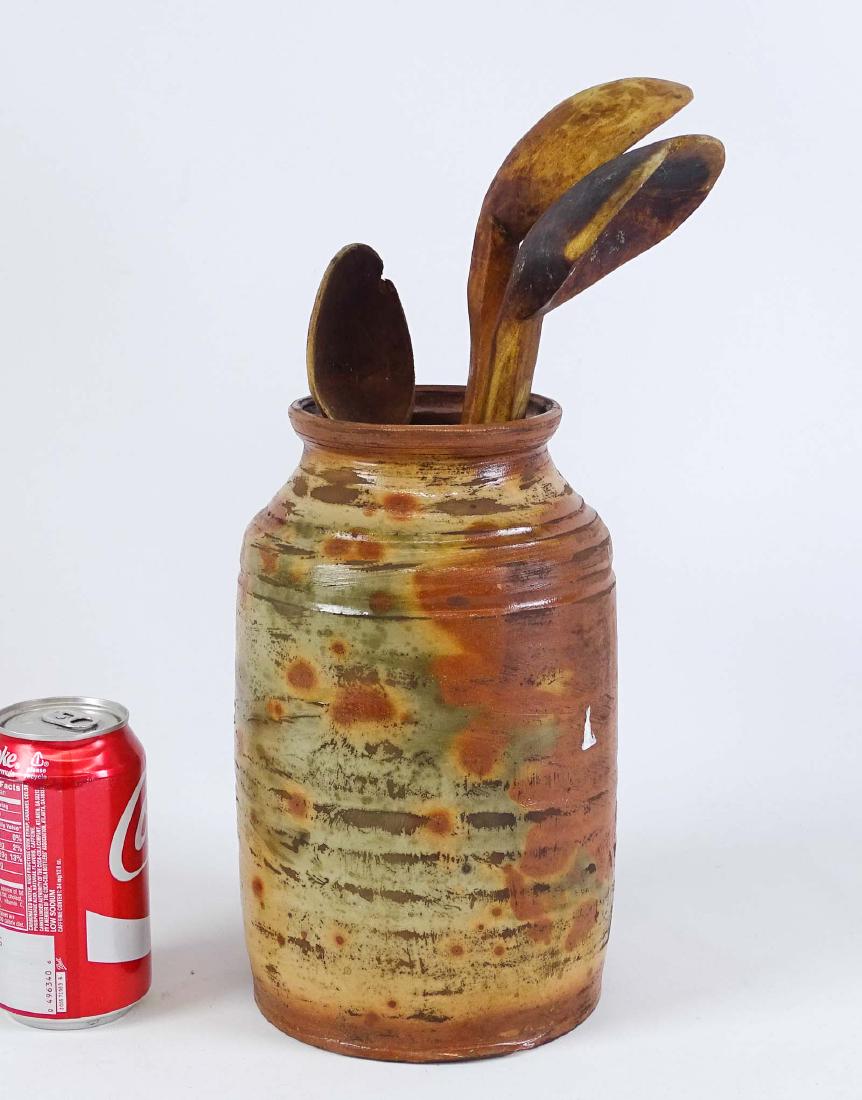 Redware Jar With Utensils: Redware jar with utensils.